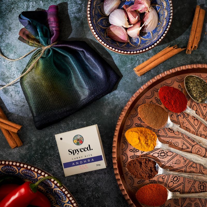 A Spyced gift bag and colourful Andhra spices displayed in teaspoons